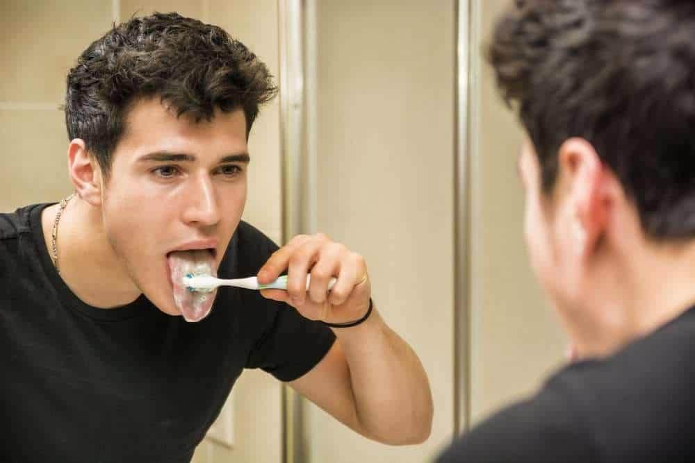 cleaning tongue with toothbrush