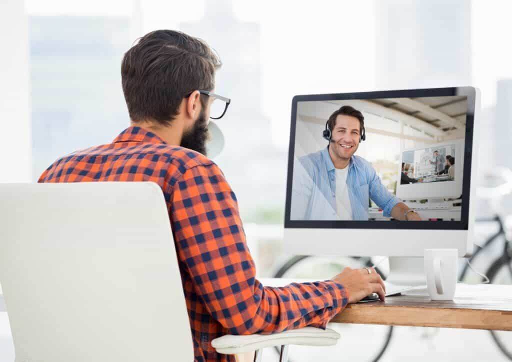 29318256 man having video call with his colleague