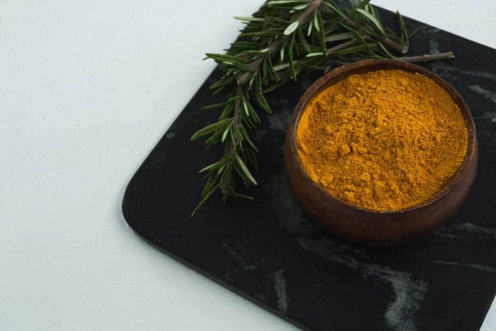 29618668 rosemary with turmeric powder in bowl
