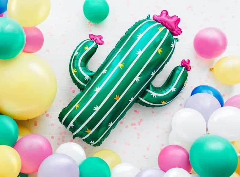A toy cactus with colorful balloons.
