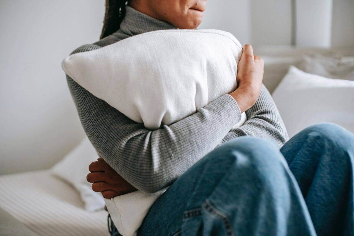 A woman embracing pillow.