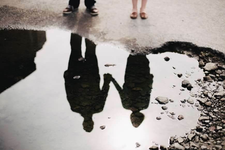 Reflection of a couple in the water.