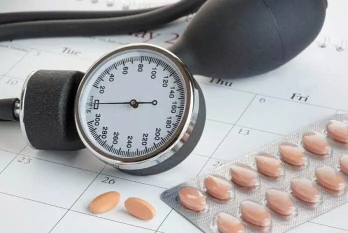Statins or generic medicines on a calendar with a sphygmanometer. Medical check up concept.